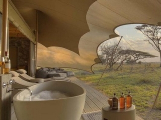 wetu_-_namiri_plains_-_tent_deck_with_bath_sunbeds_and_cushion_corner_1
