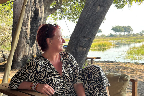 Southern Destinations travel designer Liesl Matthews relaxing beside the Okavango Delta during safari in Botswana.