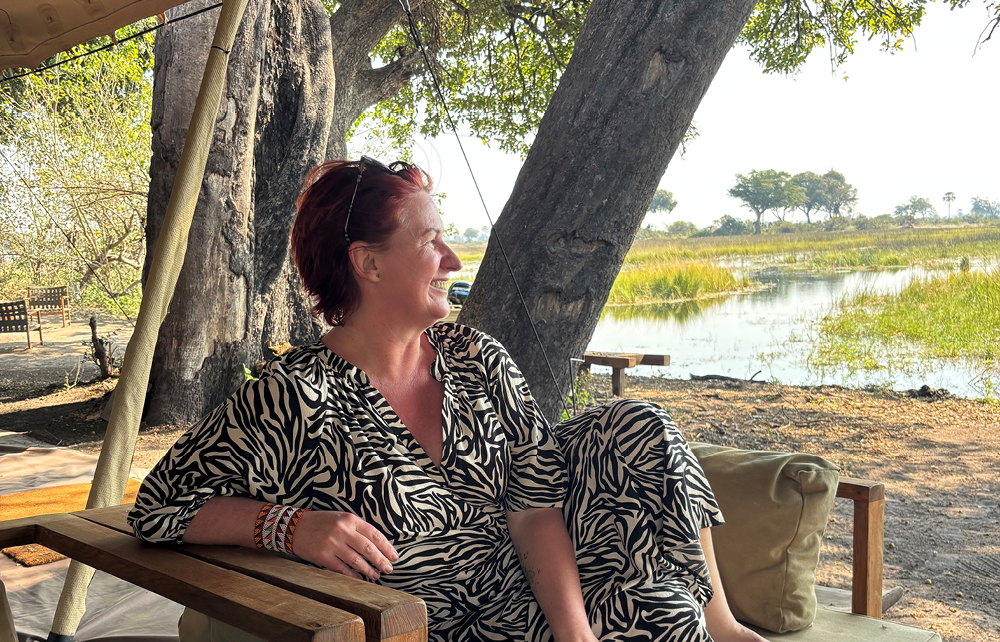 Southern Destinations travel designer Liesl Matthews relaxing beside the Okavango Delta during safari in Botswana.